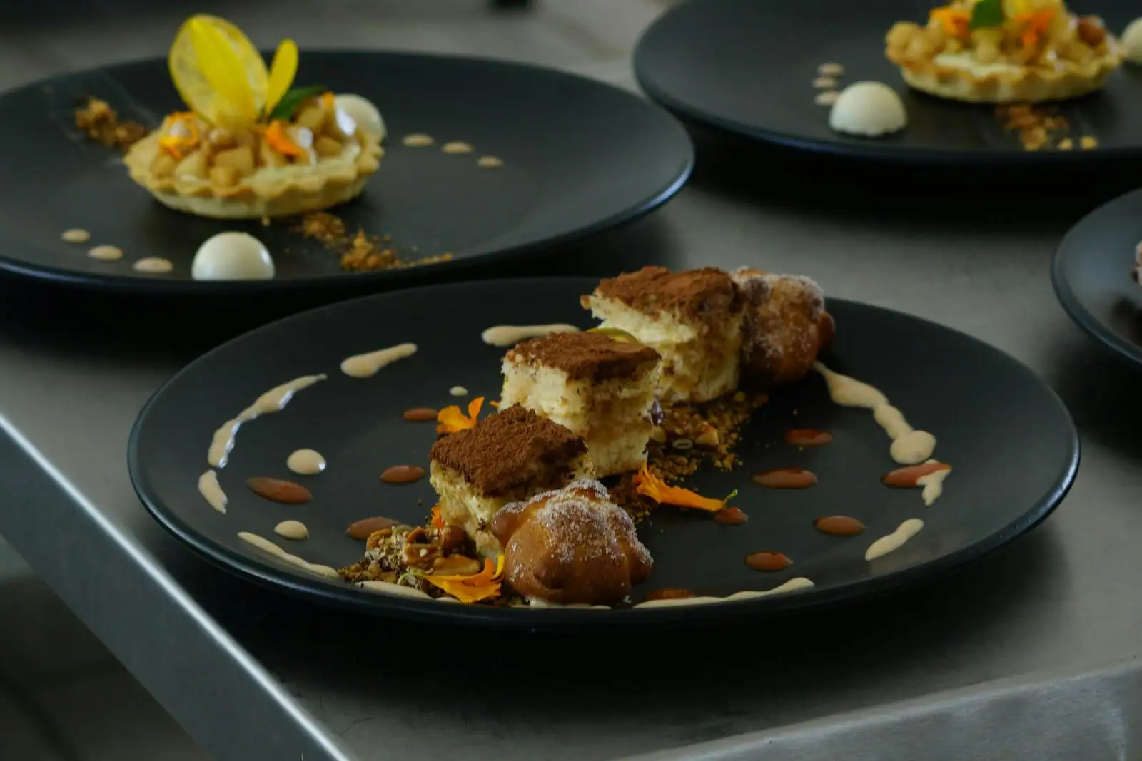 Plateau de mignardises pâtissières variées posé sur une table, ambiance fin de repas conviviale